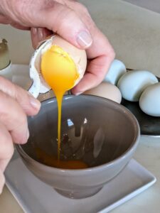 Here's another egg with its creamy egg yolk pouring out into the bowl - made to perfection. Minutes really make a difference, but after doing this a few times, one will find their perfectly cooked egg.