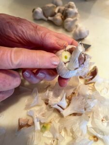 Not a lot - just a thin, quarter-inch slice from the top of each head of garlic.