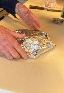Finally, seal the garlic in the foil to form a packet like this.