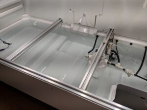 The seed trays sit over these reservoirs and are automatically watered from the back of the unit. The Urban Cultivator Commercial model uses only about 32-gallons of water a week to refill and clean the reservoir.