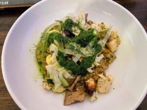 The farro verde risotto includes roasted cauliflower, mushroom conserva, salsa verde, and fennel.