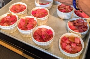 Moises fills the ramekins with the rhubarb. Ramekins are great for serving individual fruit crisps. Chef Pierre uses a streusel topping made with flour, light brown sugar, cinnamon, salt and butter.