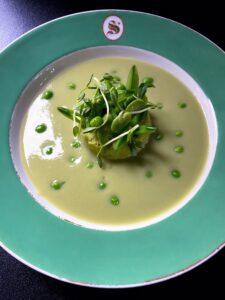 The pea flan was served with the pea soup and topped with pea shoots.