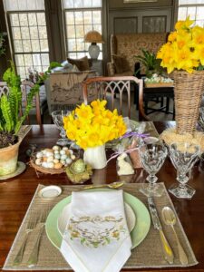 The table settings are always so beautiful. We paired light green, white and natural tan plates and linens, so the bright Easter colors and decorations would stand out.