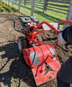 On rear-tine tillers like this, wheels are standard operating equipment. This particular model has a 20-inch tilling width. Most tillers have an accelerator on or near the handle or on the engine.