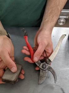 First, Brian uses a special cleaning block to remove any dirt, sap or other debris. This little scouring block is called a Creaning Mate by Niwaki. It has a slightly rough texture for removing grime from the blades.
