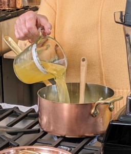 I also made a spring pea soup. This soup can be enjoyed warm or served chilled for a refreshing spring dinner. Here I am pouring in the chicken stock.