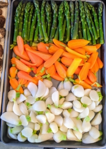 All the vegetables are cut and placed on a baking sheet ready for roasting.