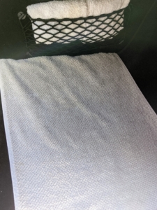 Andres also places a towel on the floor of both the driver's side and the front passenger side seats - with the ends tucked under the car's floor mats. Towels keep the area clean and are easy to pick up and throw in the wash at the end of the day.