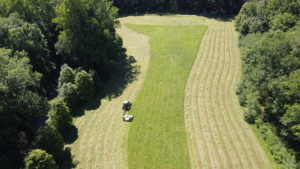 Here is a view from above. Chhiring's son, MingMar, took the next few photos with a drone. The mounded rows are called windrows – rows of cut hay or small grain crops. They are so beautiful and all perfectly straight.