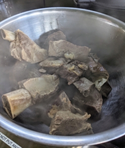 Here is the pot of beef cooking. After it is cooked and cooled to the touch, it is removed from the bone and chopped into medium to large chunks. Any carcasses are set aside to go to the coyotes. Nothing is wasted at my farm.