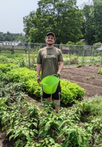 Here's Ryan just before harvesting this week's bounty. One can harvest any time of day, but when possible, the best picking time is early morning, when the sun is just clearing the eastern horizon and greens are still cool and dew-covered from the previous night.