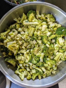 This is a bowl of chopped, cooked broccoli heads. We cooked all the vegetables separately and placed them in big stainless steel bowls. All my food is completely organic and full of flavor.