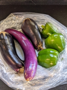 We also harvested a few eggplants. I like to pick them when they’re smaller - when they are young and tender. Picking a little early will encourage the plant to grow more, and will help to extend the growing season. Sweet peppers are often harvested when the fruit is still green, but full sized. We picked three bell peppers, but more are growing in the garden bed.