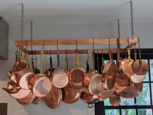 I have a lot of copper pots and pans and other kitchen pieces. I like to keep a lot of my pots hanging on a rack where they are easy to reach. Copper was actually one of the first metals used by humans more than 10-thousand years ago, and it remains a common household material today. Polishing copper, silver, brass or any other metal three or four times a year is generally sufficient to keep it in good condition.