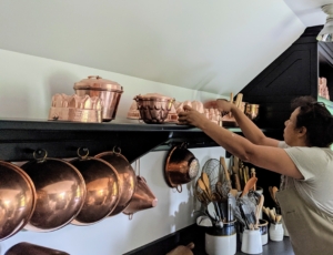 Elvira places the molds carefully on this shelf. I will be using this kitchen a lot going forward - for television and magazine shoots and for other media appearances. It's important that it is always clean and "camera-ready."