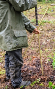 Then Chhiring pounds the bamboo securely into the ground - about a foot deep to make sure it can withstand any winds that blow through the area.