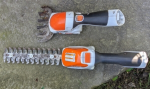 This tool has two attachments – grass shears and shrub/hedge shears. The top is the grass shear attachment, which is helpful in cutting the grass around my fence posts. The bottom is the hedge shear attachment. And each fully charged battery lasts 110-minutes.