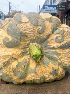The design on this pumpkin pays homage to the sea with carved mermaids.