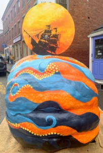 The artist for this 538 pound pumpkin paints a kraken threatening a ship on the surface of the ocean.