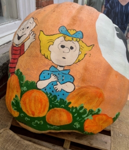 Ode to Charles Schultz, this pumpkin shows Peanuts characters from the "Great Pumpkin" show. On this side, Linus and Lucy.