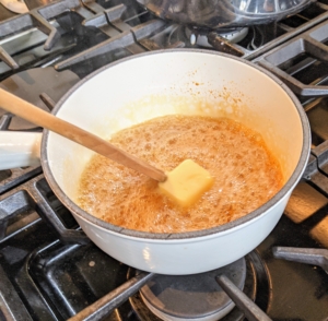 Caramel sauce is also made in another saucepan with butter and sugar.