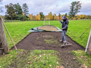 Pete rakes the area clean of any old sod and debris. Doing this levels the area and removes any pre-existing ruts which could hinder proper drainage.