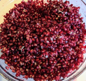 The pomegranates are all emptied of seeds and then strained to make a gorgeous bright colored sorbet.