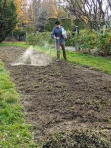Next, Brian sprinkles a coating of organic fertilizer over the entire bed.