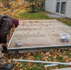 Here, Chhiring works on the a/c pits. These air conditioner pits are covered with industrial strength plastic, and plywood to protect them from the winter elements. I keep all my air conditioners in large pits, where they are well hidden behind each house.