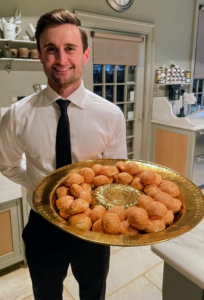 Guests also enjoyed hors d’oeuvres - gougeres, or airy French cheese puffs, flavored with Gruyere cheese. This is Tyler Salamone, one of the evening's wait staff.
