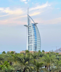 This sail-shaped hotel is the Burj Al Arab. It sits on its own manmade island in Dubai's harbor. It is accessed via its own helipad near the roof at a height of 689 feet above ground.