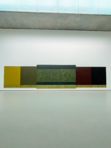This is called “Moss Sutra with the Seasons” (2010–2015) by Brice Marden. It measures nine feet by 39-feet. Each of these monochromatic panels is inspired by a season, beginning at the left with the yellow of springtime and ending on the right with the blue-black of winter.