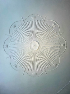 The ornamental plaster ceiling was made by Irish plasterer Richard Tharpe in the late 1780s. The ceiling features neoclassical detailing—swags, husks, and ovals. Documentation and conservation work in 2018 confirmed that much of the 18th-century ceiling ornament still survives.