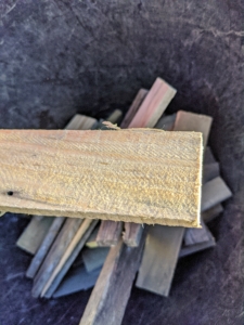 The strips are four to six inches long – just long enough to accommodate two or three screws that will keep the burlap secure. These are also reused year after year – nothing is wasted at my farm.