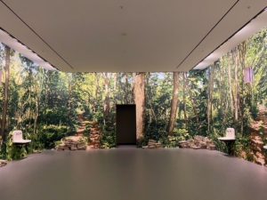 This is an entire room installation by artist Robert Gober. The 1992 "Untitled" work is a room-scale, multi-sensory presentation made up of darkened exterior pathways, a brightly lit interior chamber, and walls covered by hand-painted, 360-degree murals depicting a forest.