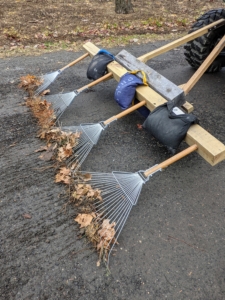 It is made from four soft garden rakes attached to a wooden frame. It is crucial to maintain gravel roads, so water can flow properly during storms.