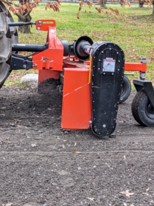 As the tractor and power rake drive over it - very slowly - about three miles per hour, it moves the gravel and dust to level the area and get rid of the depression.