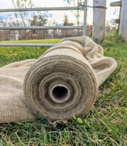Meanwhile, Chhiring rolls out sections of burlap to be sewn. The long pieces of burlap are measured to fit each section. After it is removed in spring, it will be labeled, folded and stored in a dry place for use the following year.