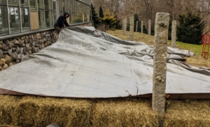 Brian and Phurba spread the tarps across the bed and in between the posts.