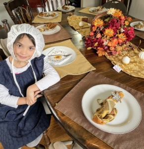 Seven year old Adriana loves a theme and set the table for the family gathering.