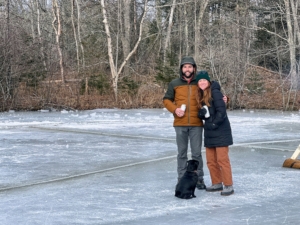 Ben and Katie Fearn own the pond. This is their second annual ice carrousel. They're hoping to make it an annual tradition. Here they are with their black Pug, Rudy.