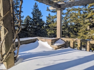 This is a view from the West Terrace looking out through the tall spruce trees to Seal Harbor. On this day, the skies over Skylands are a beautiful bright blue.