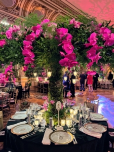 Hilary Pereira and JSA Studio NYC created this pink and bold green centerpiece with its sprays of flowers over every place setting.
