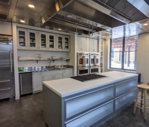 Here's a view of our test kitchen, where all our book and magazine recipes are tested and retested until they're perfect. It is complete with lots of light, large working islands, multiple commercial refrigerators and freezers, and side-by-side door wall ovens.