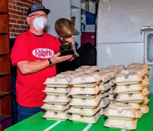 Here, a volunteer stands next to some of the meal kits he helped prepare. Did his team come out victorious? (Photo by Ethan Glanger)