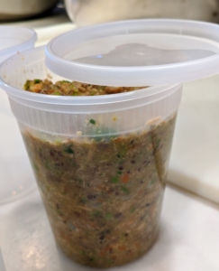If planning to freeze, only fill up to the first line around the container so it has room to expand. The quarts of food are left to cool a bit before securing the lids.