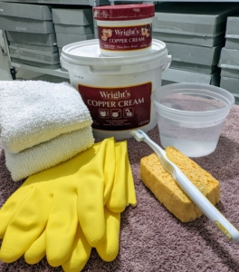 For cleaning, I have long used Wright's Copper and Brass Cleaning Cream. It comes in small and large sizes. For this task, Carlos also gathers soft rags, rubber gloves, sponges, an old soft-bristled toothbrush, and some water. I always tell my team to collect all the needed supplies first, so it saves time hunting them down later.