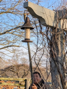 Phurba uses the long pole to return the feeder to its hook - always careful not to step in the garden bed below, especially at this time as many of the precious bulbs are just beginning to emerge.