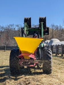 Once the spreader is attached and filled with enough seed, Chhiring heads out to the paddock again to begin overseeding - a process where grass seed is added to an already existing area which after germination serves to increase the density of the grass plants. This process reduces the aging process or natural decline of the turf.